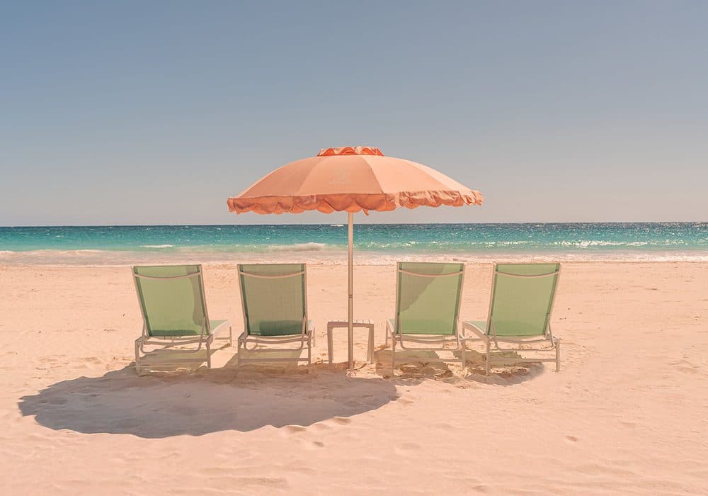 beach lounge chairs facing the ocean