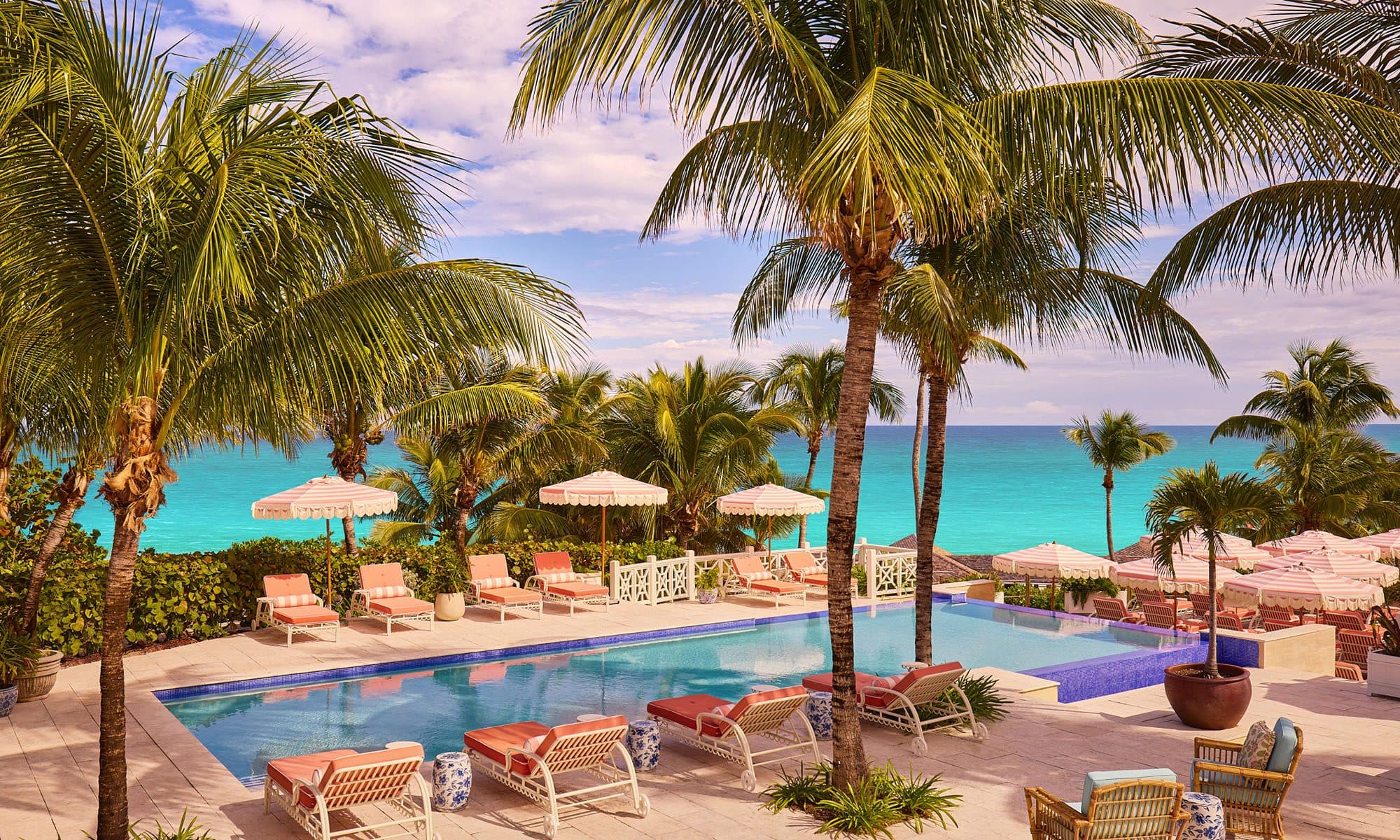 pool deck with loungers and ocean beyond