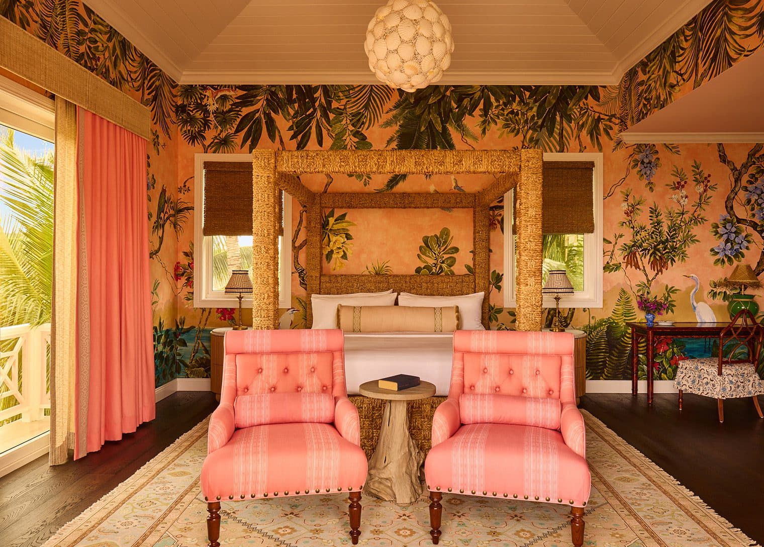 pink lounge chairs in front of king bed