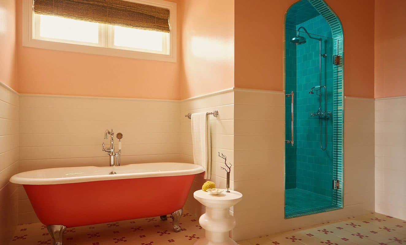 pink clawfoot tub and turquoise tiled shower