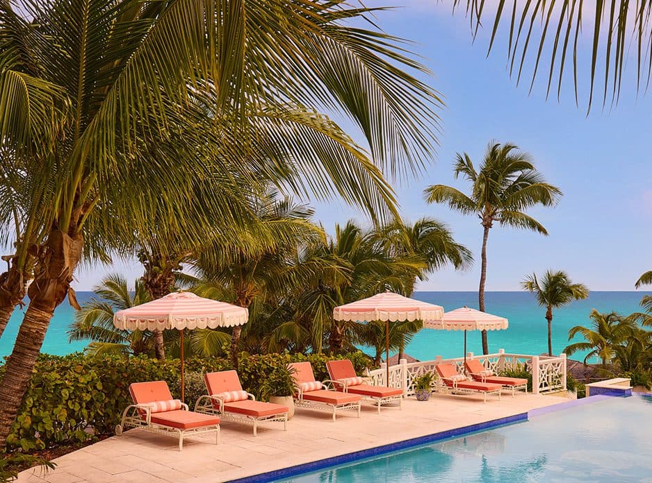 pink loung chairs and umbrellas at the pool