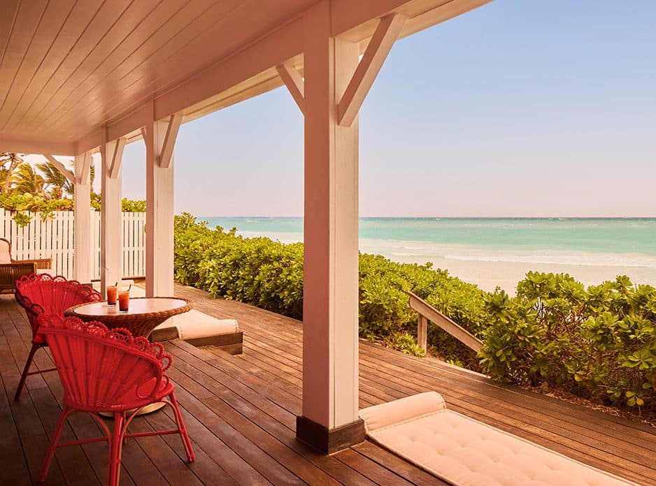 porch with stairs down to the pink sand beach