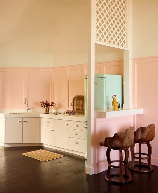 full kitchen and counter with two barstools